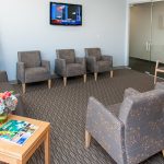 Reception 6 chairs on an angle, large sofa and large window on the right, lobby of Stewart & Arango Oral Surgery